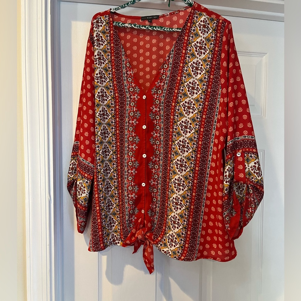 Red patterned light button down blouse.
